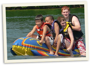 Enjoying the water at Lake Anna four boys on a raft
